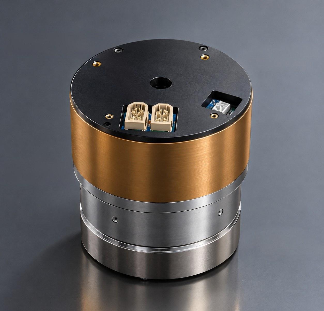 Dreambot joint actuator: cylindrical housing with copper and steel sections, black top plate and connectors